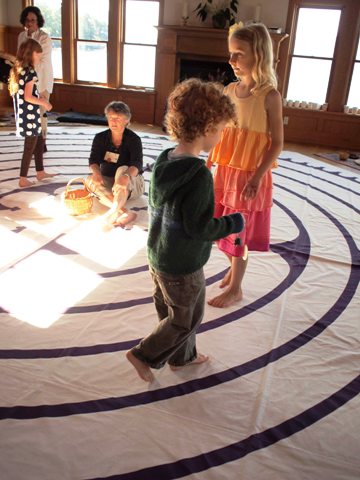 children walking an indoor Labyrinth